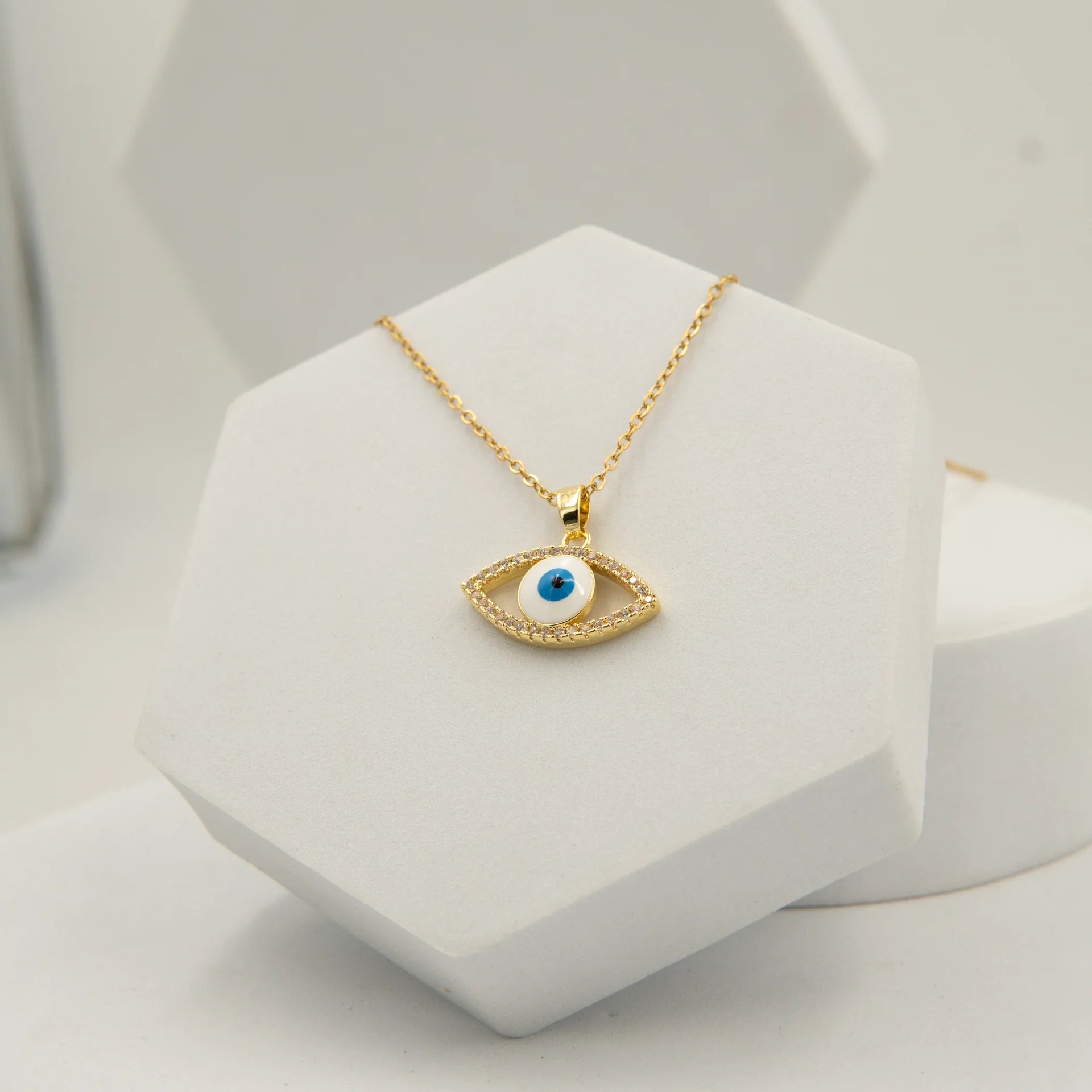 Gold evil eye necklace with blue center and zircon stones in stainless steel pendant